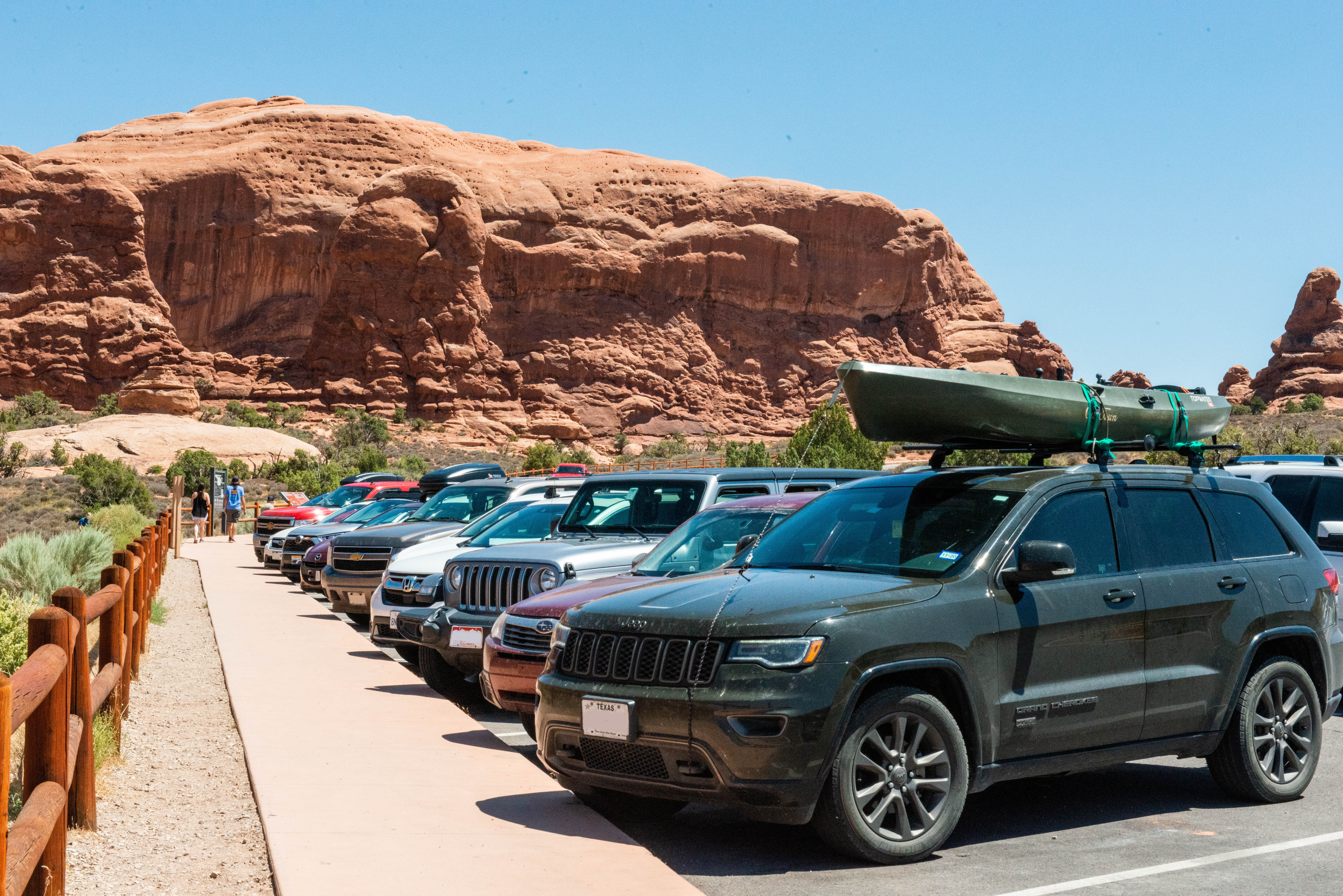 Cars fill a parking lot in Arches National Park