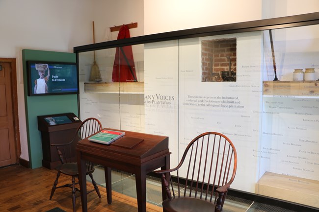 A glass wall with many names written on it.