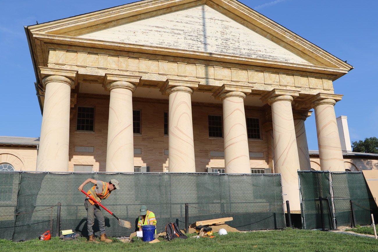 Archeologists dig in front of Arlington House.