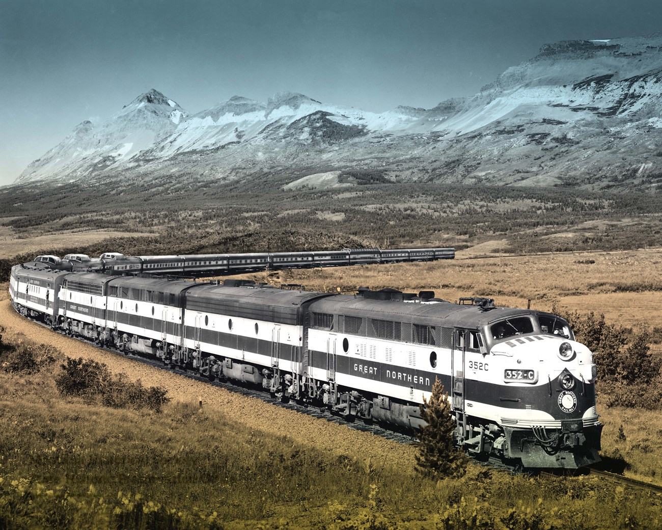 Train skirts Glacier National Park in 1955