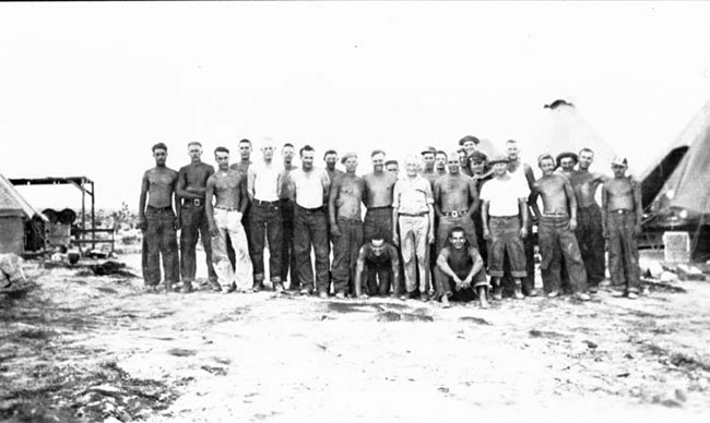 historic photo of a group of men standing outdoors