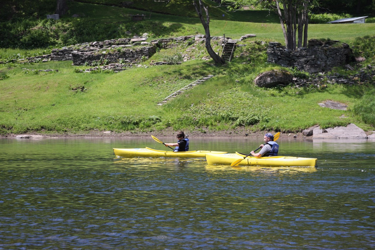 Two yellow kayaks on the river.