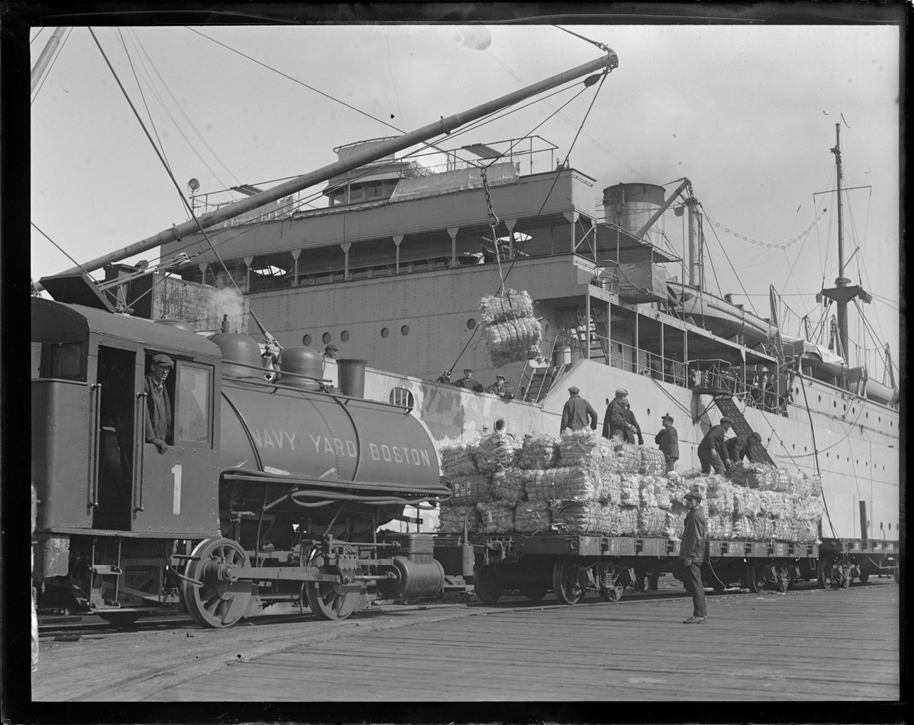 Steam locomotive being used to transport hemp used for rope.