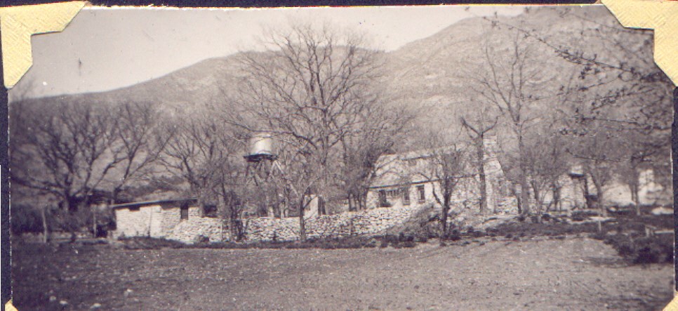 Frijole Ranch, 1930s A black and white phto of a ranch compound inside a stone fence