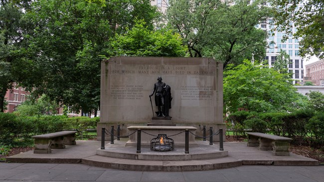 Inscription behind the statue of George Washington and the eternal flame: "Freedom is a light for which many men have died in darkness in unmarked graves."