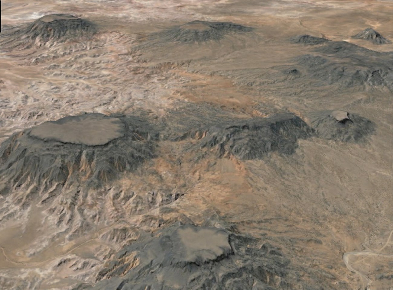 oblique aerial photo of a desert landscape with several mesas