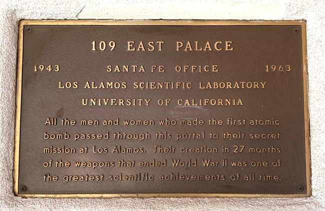 Bronze plaque that reads in part 109 East Place 1943 Santa Fe Office 1963. Los Alamos Scientific Laboratory. University of California. 