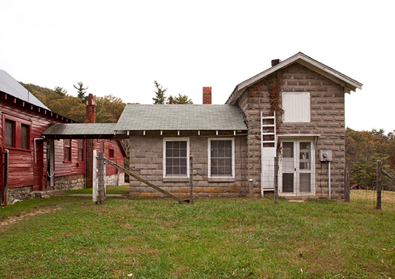 11 milk house image A gray stone building is connected to the Goat Barn by a covered walkway