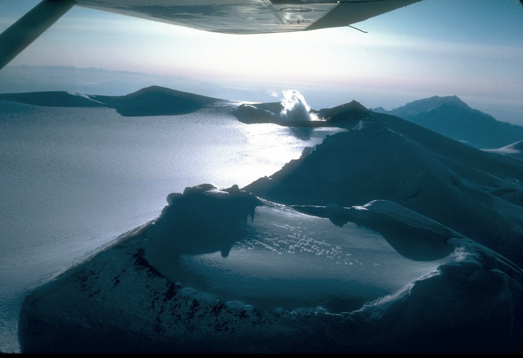 aerial photo of a summit crater filled with ice and snow