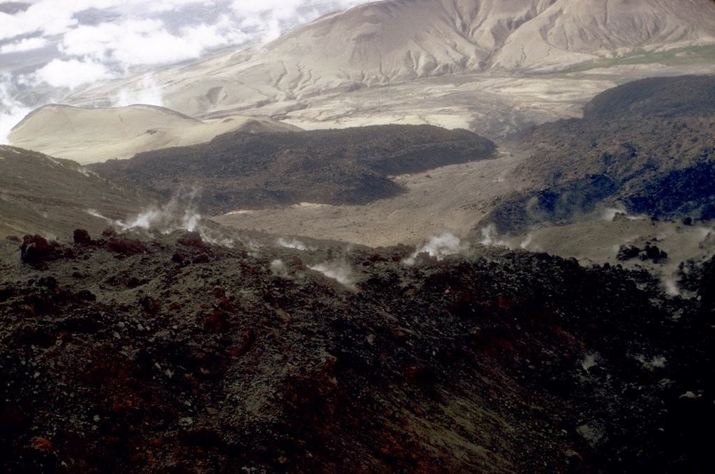 photo of a mountain valley with the near slope covered with blocky lava.