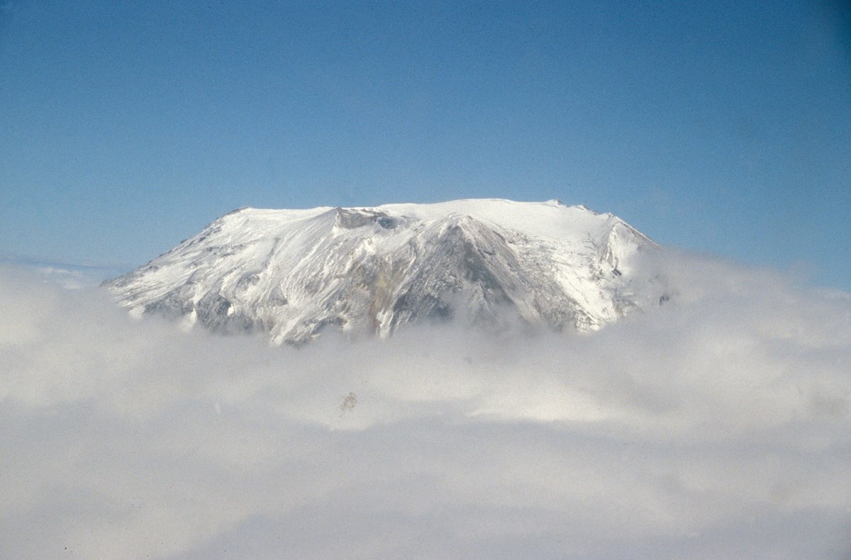 flat topped volcanic peak covered with snow and ice
