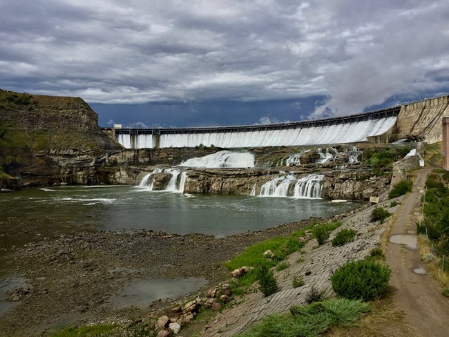 large dam with clouds in the background