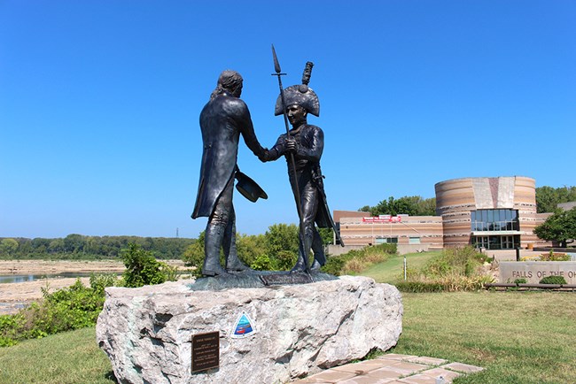 statue of two men shaking hands