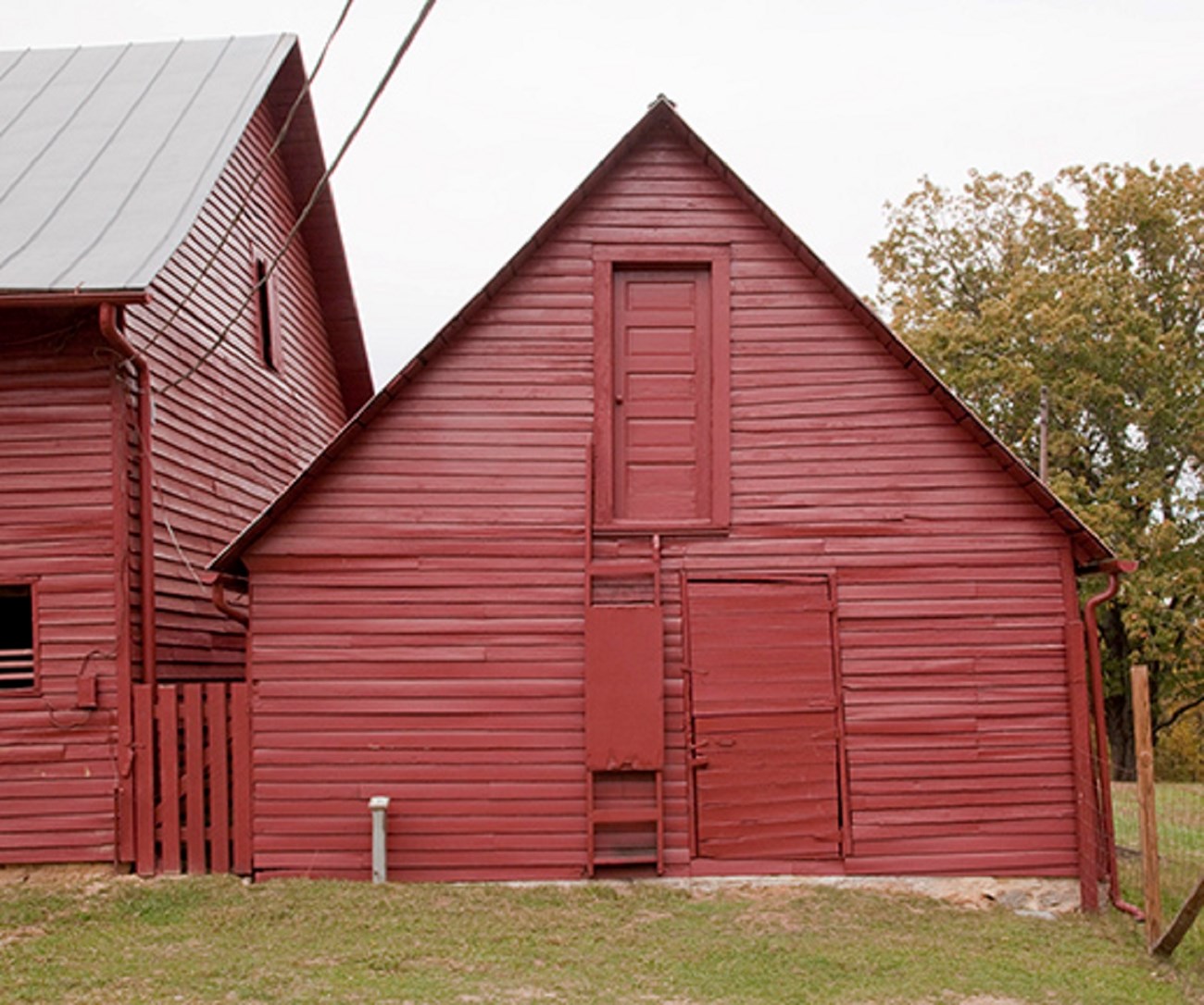12 horse barn image A smaller red barn next to the large goat barn