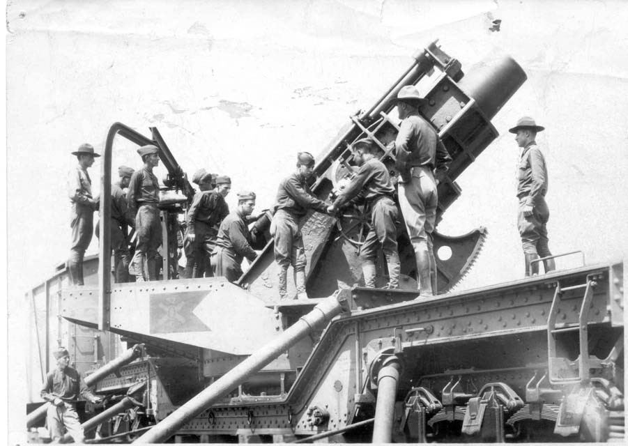 a group of men standing atop a railway mortar