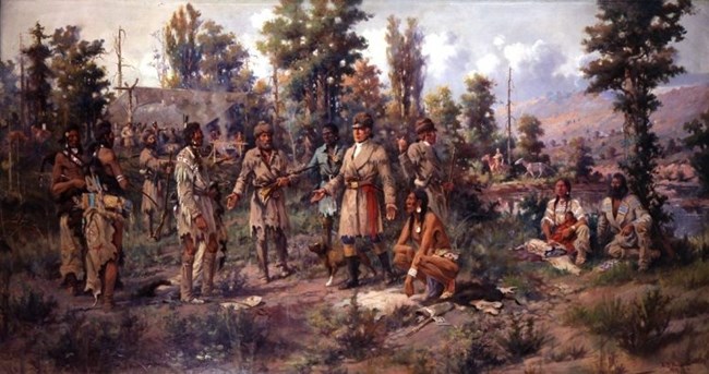 1218 A painting shows Lewis and Clark meeting with Native people in a wooded setting. Sacagawea and Charbonneau are seated on the ground at the far right of the painting.