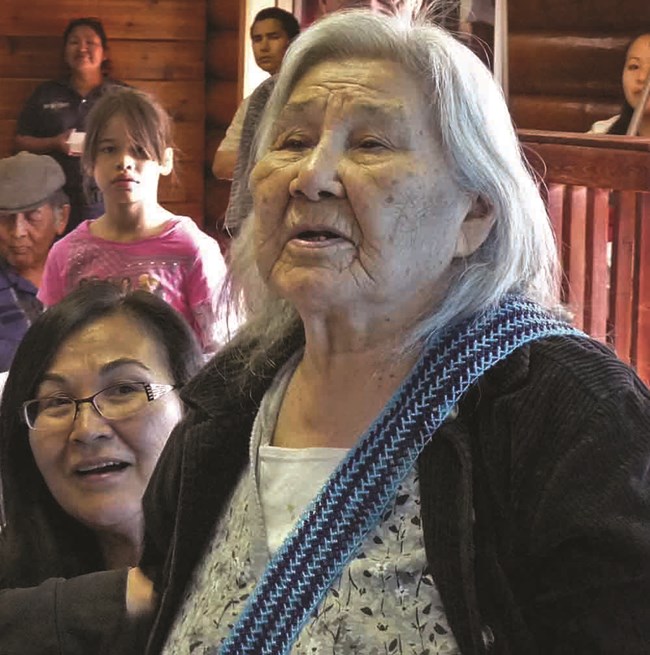 Katie John testifies at a community meeting.