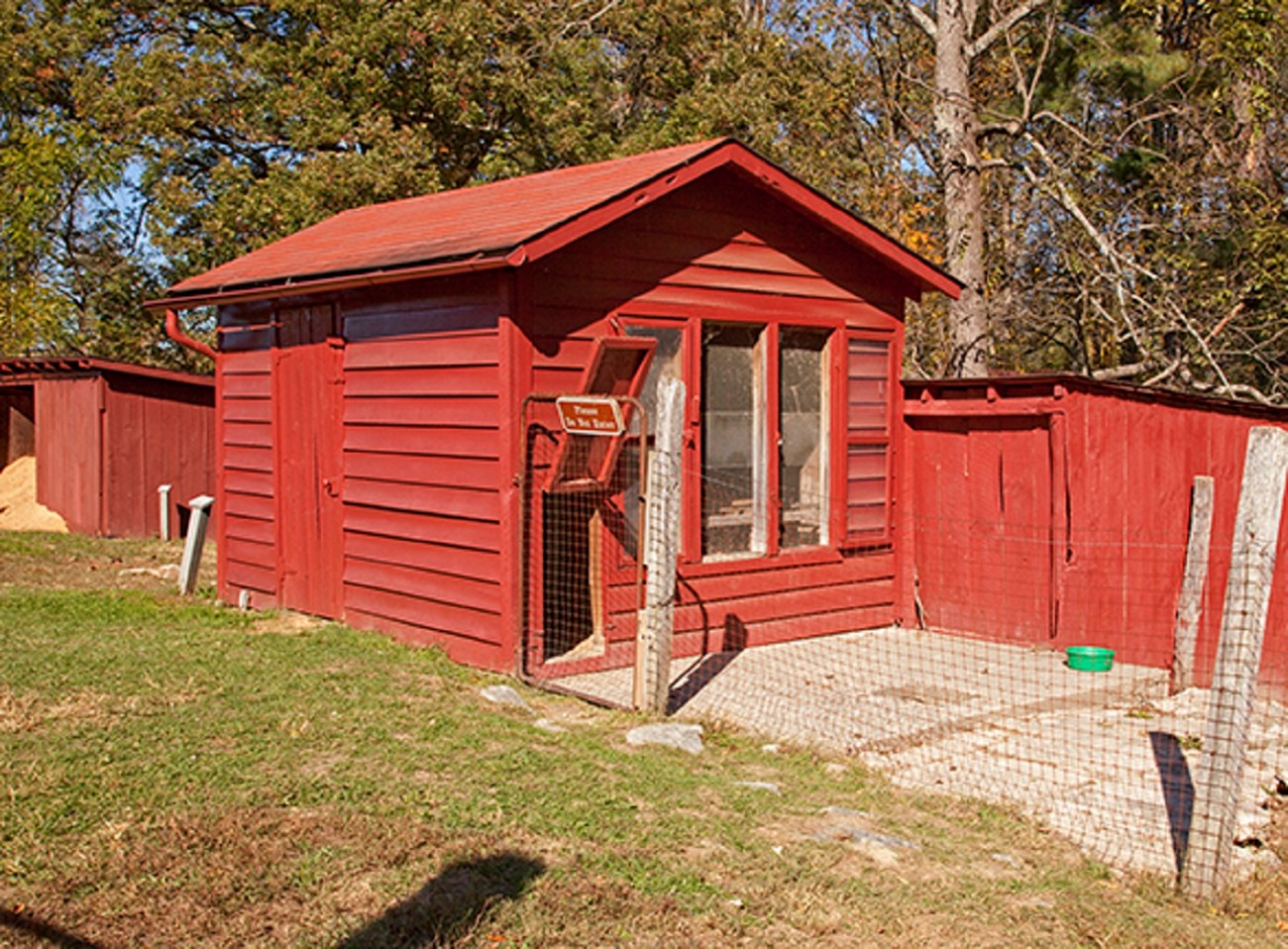 13-14 cow and storage sheds image A row of barn red buildings and fenced areas