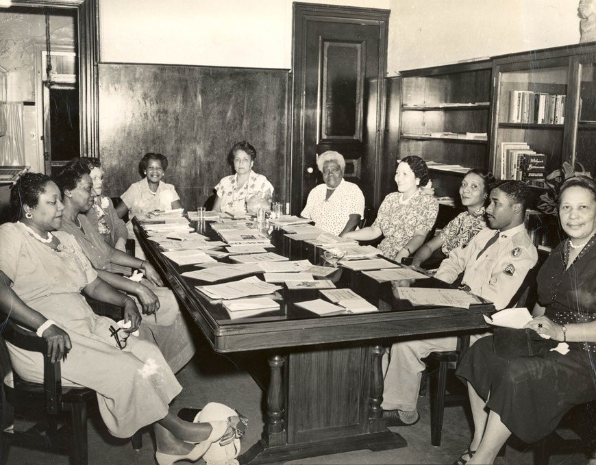 Group of people sitting around a table.