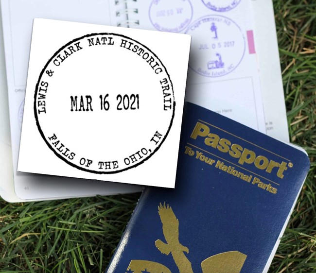 1427 A Passport to America’s National Park book – one opened to a page with several round passport stamps