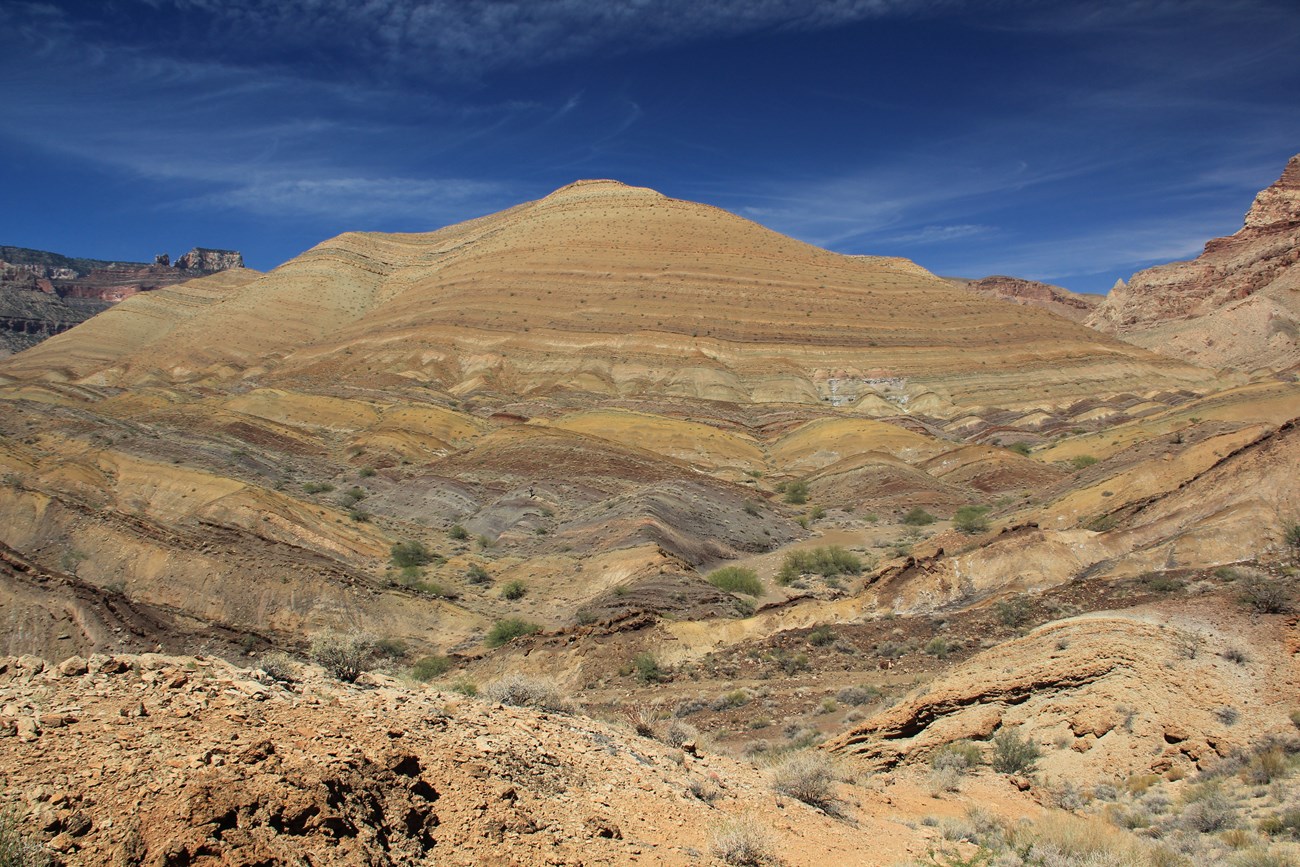 Photo of hillside with layered rock.