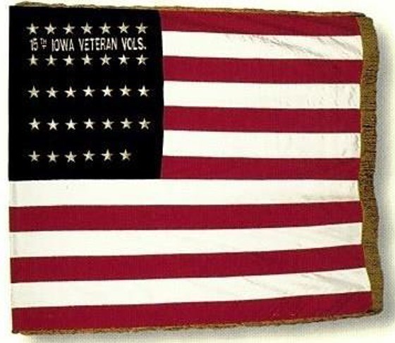 American flag with white writing in blue canton