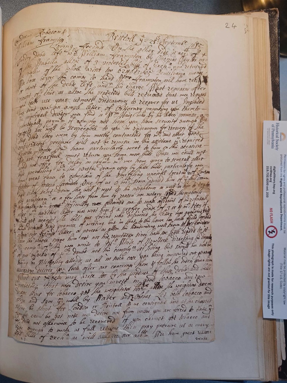 The first page of a four-page letter written from Jones & Company to Andrew Robeson and William Frampton on September 28, 1685. black ink handwriting on paper attached to a page of a book
