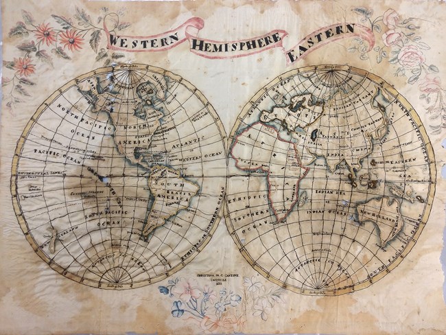 1813_Cantine_Map Antique 1813 world map showing the Western and Eastern Hemispheres with hand-drawn floral decorations.
