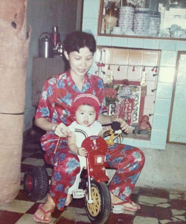 Growing up with mom A baby Becca riding a bike indoors with her mom in Saigon, Vietnam