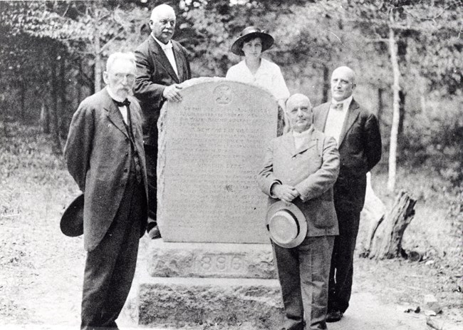 1896 Monument dedication by RCMA historic image of several people standing around a monument