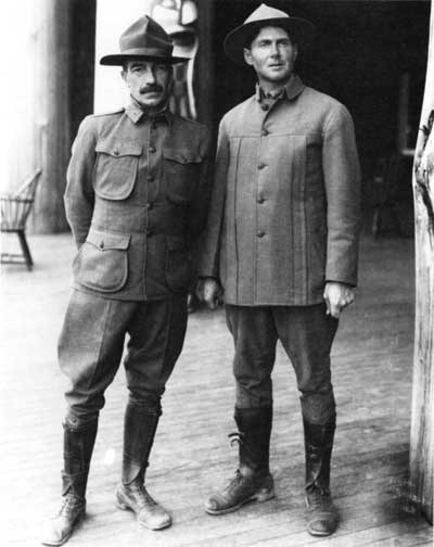 Two men standing next to each other in different uniforms