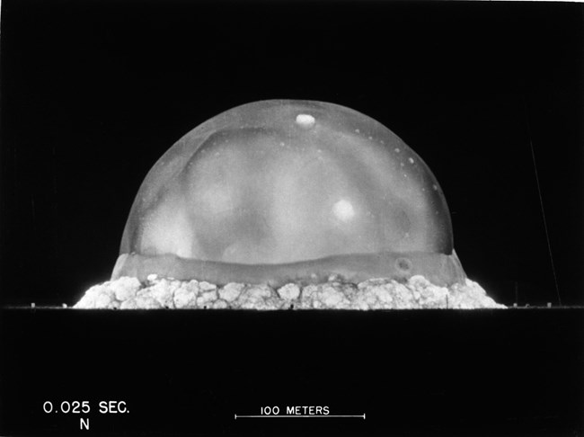 Black and white photo of nuclear explosion, a large dome-shaped blob