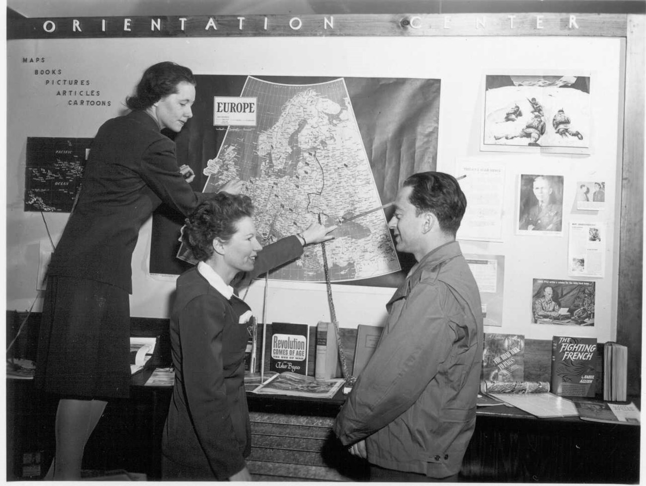 1944-273 library wac two female army corps members point at a large map of Europe on the wall