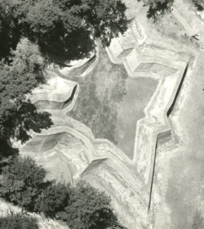 A historic aerial image of the Fort Raleigh earthworks showing its diamond pattern