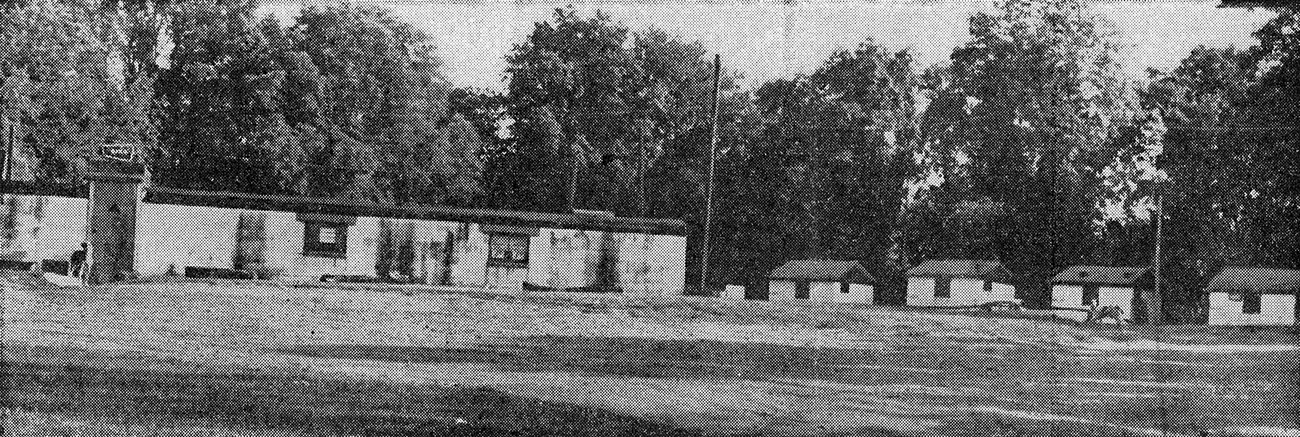 Grainy, black and white clipping of newsprint shows a one story, cement-block club with 4 small cabins to the right.