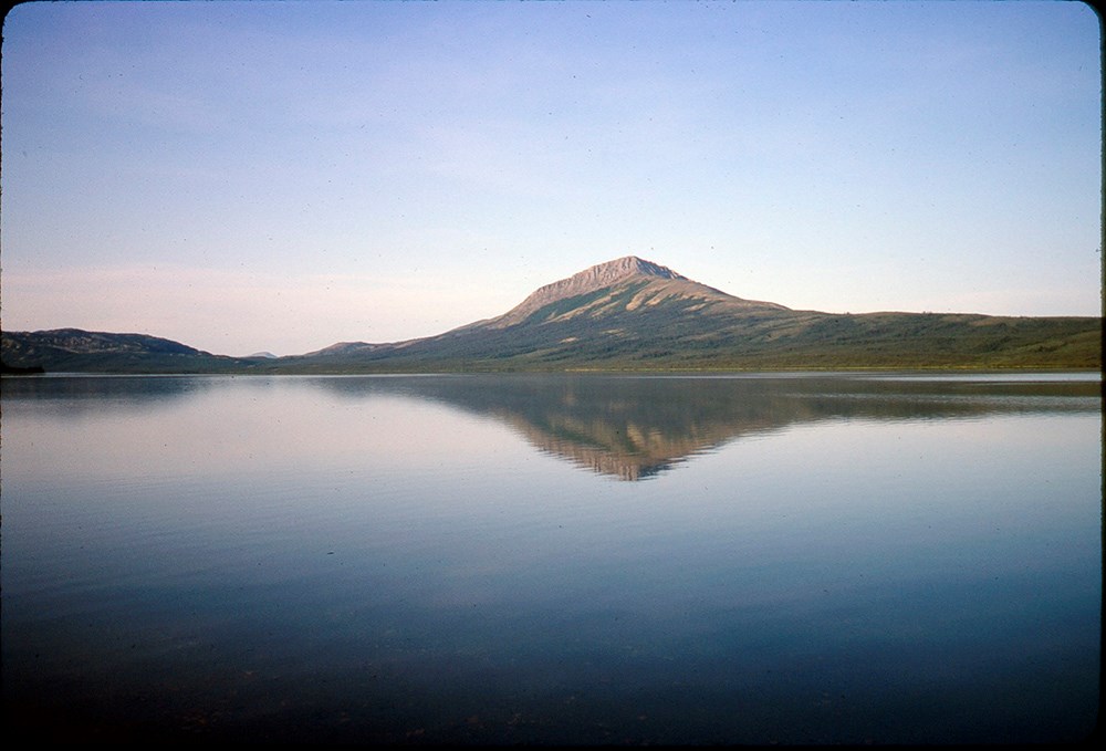 A large lake with a mountain and its reflection.