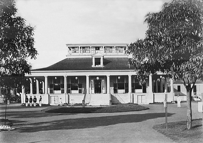 House with large wrap around porch and a smaller second story