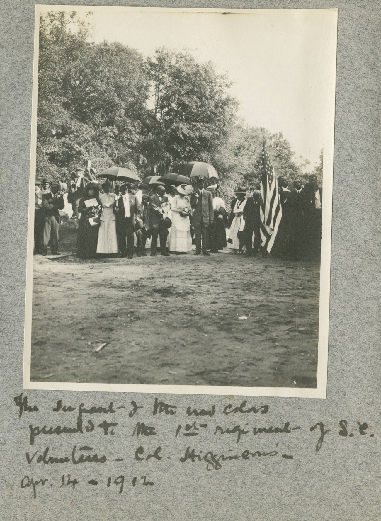 1st South Carolina Colors in 1912 A scrapbook page with a photo of a group of 1st South Veterans with a flag in 1912.