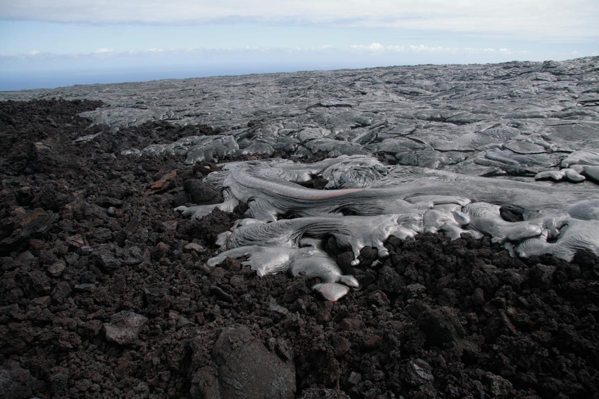 photo of smooth lava flow over a rough blocky lava surface