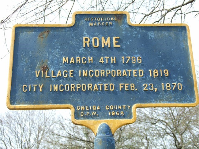 A NYS historic marker. It reads: Rome. March 4th 1796. Village Incorporated 1819. City Incorporated Feb. 23rd 1870. Oneida County DPW 1968.