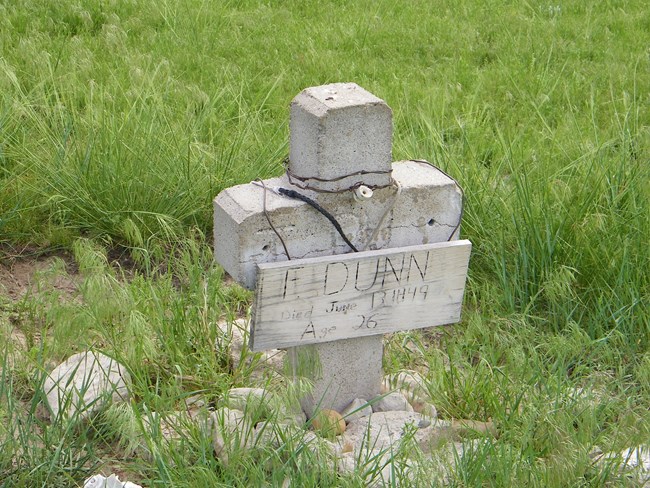 A concrete cross marks the grave site of Fleming Dunn.
