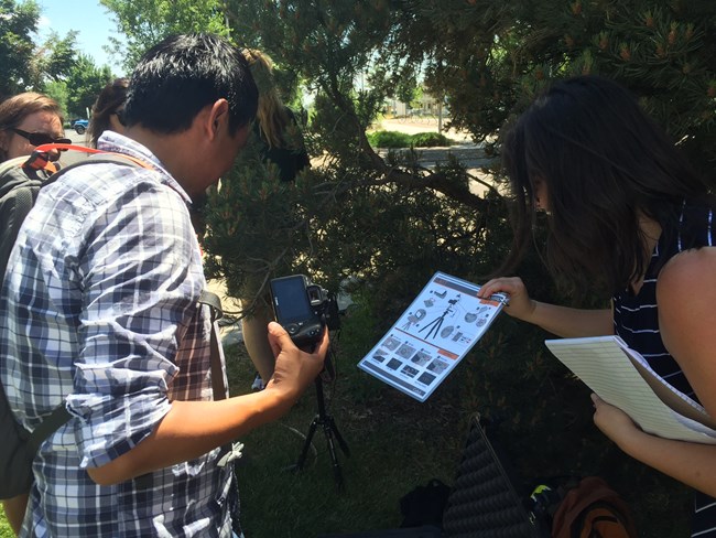 lt= 4 people with camera reading instructional guide