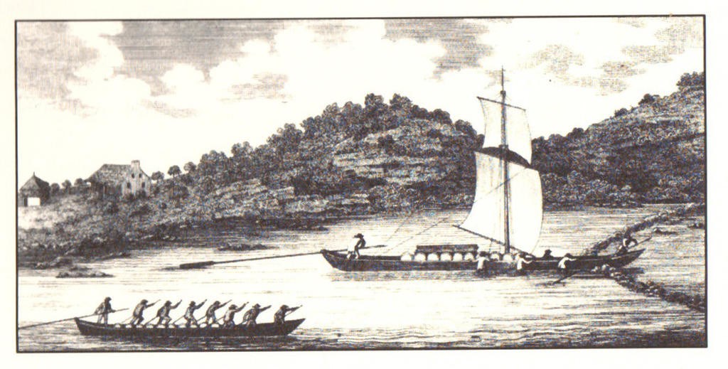A black and white print of a river with two long, skinny boats atop it. In the boats, several men stand paddling. On boat has a mast and sails.
