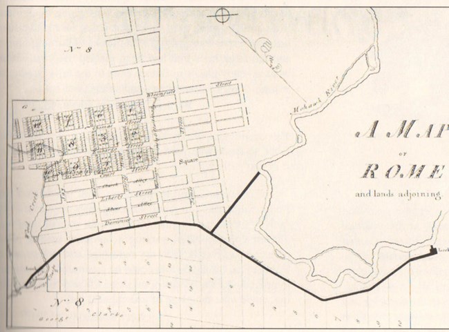 "A Map of Rome and adjoining lands." A simple hand-drawn map with a city grid in the center and a thick line dividing north and south.