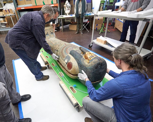 Lowering the lid of the coffin with Nesmin now inside. Photograph courtesy of the RISD Museum, Providence, RI.