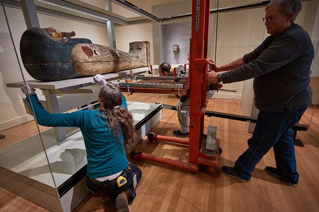 The Coffin and Mummy of Nesmin being returned to the gallery. Photograph courtesy of the RISD Museum, Providence, RI.