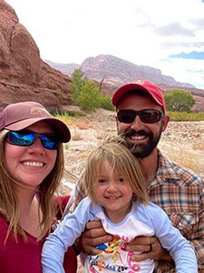 photo of a family with red rocks in the background