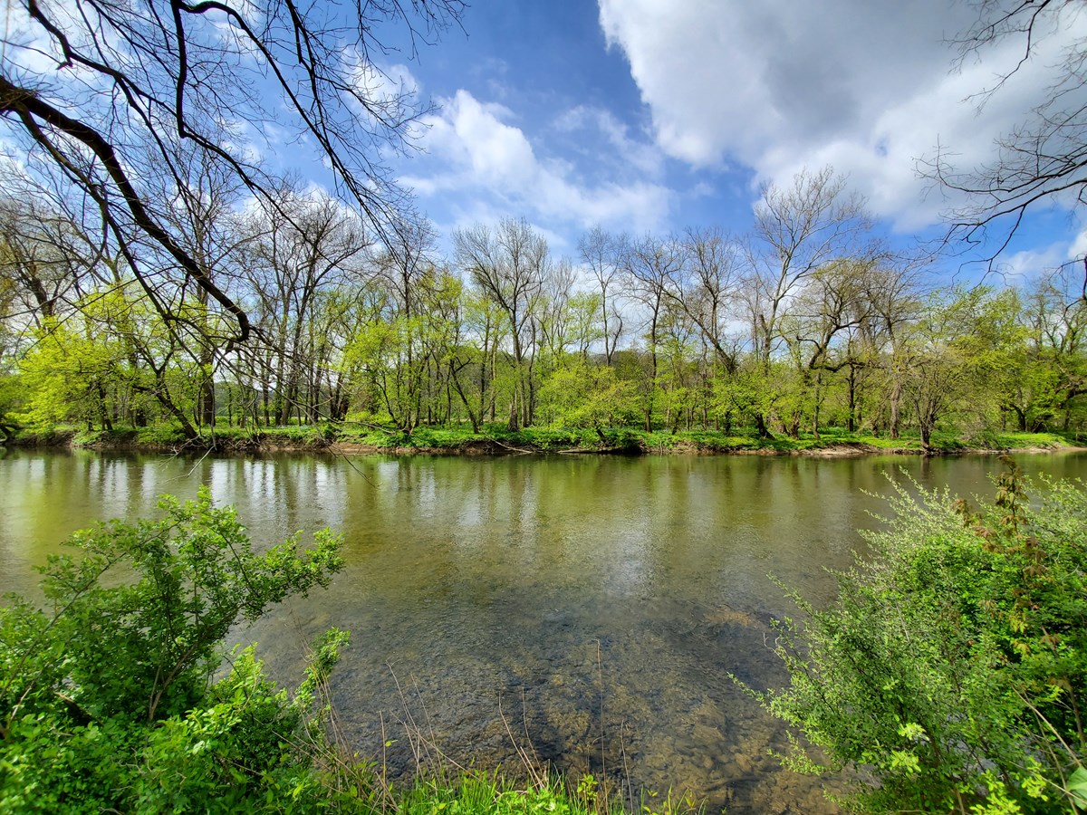 A view across the Brandywine River on a partly cloudy day.