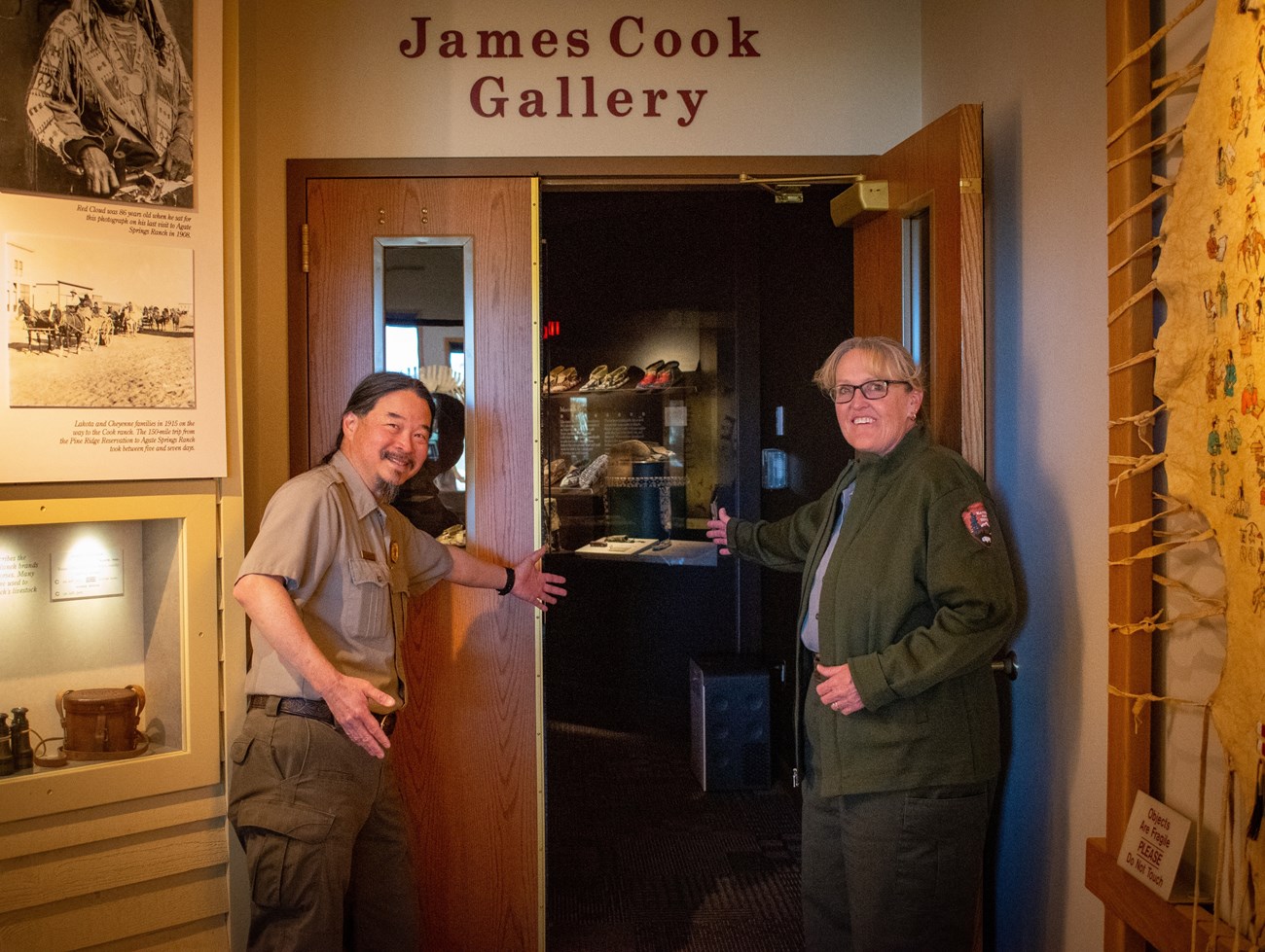 Welcome rangers Two rangers with welcoming arm poses in front of an entrance door