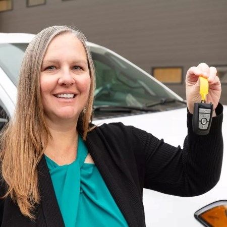 a woman holding up car keys